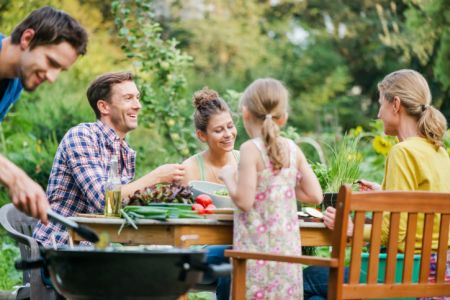Family At Barbeque In A Garden