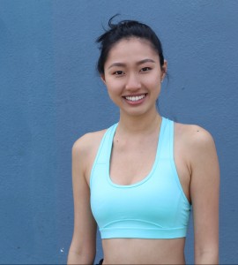 Young, sporty, fit and beautiful Asian girl isolated on blue with copy space