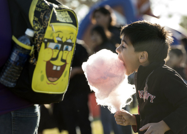 Thorman Elementary School student David Guillen, 6, takes a bite of cotton candy during Currie Middle School and Thorman Elementary's “Stronger Together-Stronger than Ever” event.