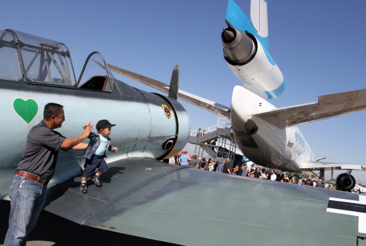 November 5, 2016-Photo by Tracey Roman/for the Press-Telegram
Bora Nhek with grandson Kristopher explore the planes at the Long Beach Flight Fest Saturday afternoon.