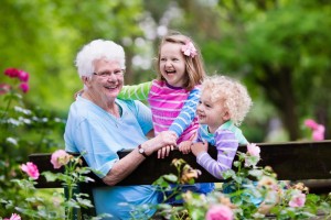 grandmother-kids-sitting-rose-garden-happy-senior-lady-playing-little-boy-girl-blooming-grand-children-bench-74612764
