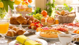 Breakfast or brunch table filled with all sorts of delicious delicatessen ready for an Easter meal.