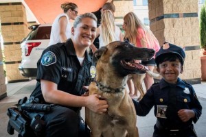 Irvine Police Officer Suzanne Paulsen lets Mihir Pillai, 6, of Foothill Ranch pet K-9 dog Barrett during the Irvine Police Department's second annual open house on Saturday, Oct. 1, 2016 at the Civic Center. The event featured tours of the police department, police vehicle displays, a bicycle rodeo, children activities, as well as food trucks, music and games. /// 10/01/016, i.1001.openhouse, Orange County Register, MICHAEL ARES, CONTRIBUTING PHOTOGRAPHER