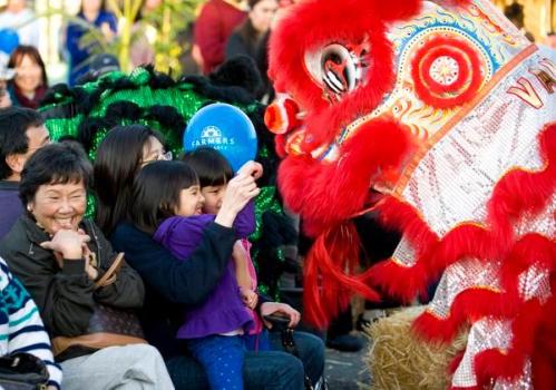 Children and adults laugh and pull away after giving money to one of the lions during a lion dance at the opening of the Tet Festival of Southern California Friday night at the Orange County Fair and Event Center in Costa Mesa.
///ADDITIONAL INFORMATION: 0208.tet.cm 2/7/14 SAM GANGWER, STAFF PHOTOGRAPHER 